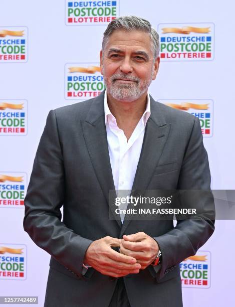 Actor and human rights activist George Clooney arrives on the red carpet for the Charity Gala of the German Postcode Lottery under the theme 'Stand...