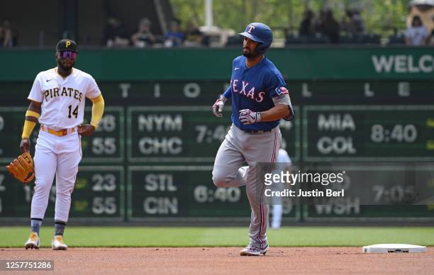 Marcus Semien of the Texas Rangers rounds the bases after hitting a solo home run in the first inning during the game against the Pittsburgh Pirates...