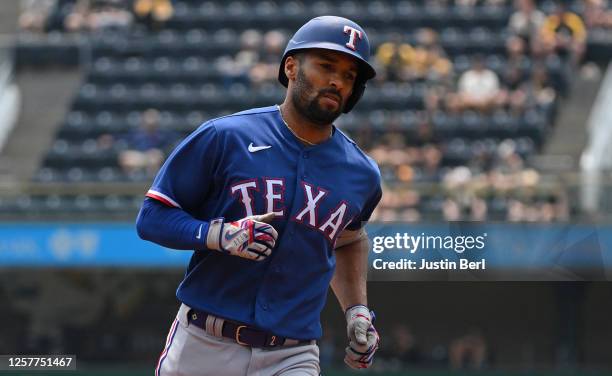 Marcus Semien of the Texas Rangers rounds the bases after hitting a solo home run in the first inning during the game against the Pittsburgh Pirates...