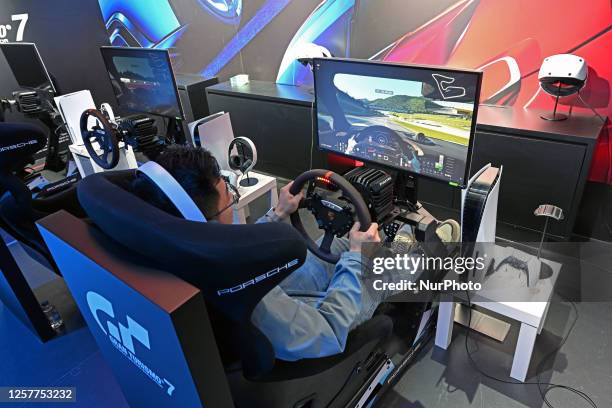 People play a PlayStation racing game at the Sony Expo 2023 in Shanghai, China, May 24, 2023.