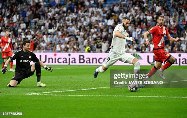 Real Madrid's French forward Karim Benzema kicks to score his team's first goal during the Spanish league football match between Real Madrid CF and...