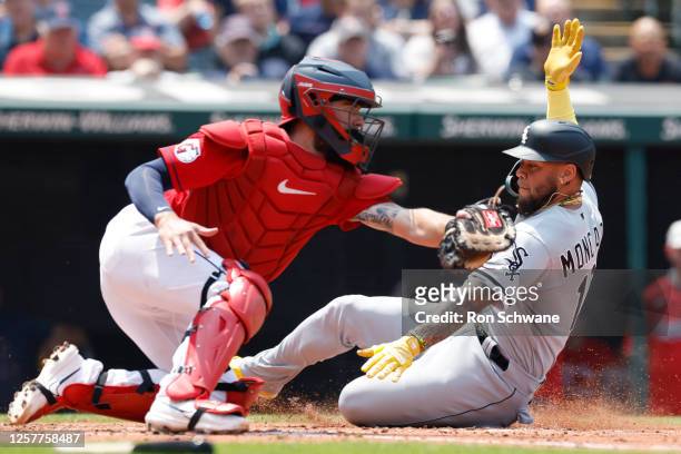 Yoan Moncada of the Chicago White Sox scores past Cam Gallagher of the Cleveland Guardians on a sacrifice fly by Jake Burger during the fourth inning...