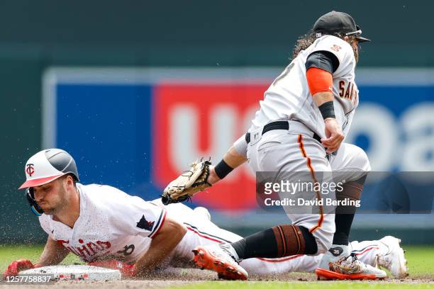Brandon Crawford of the San Francisco Giants fields the ball as Matt Wallner of the Minnesota Twins is safe at second base on his RBI double in the...