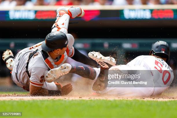 Willi Castro of the Minnesota Twins steals home to score a run against Blake Sabol of the San Francisco Giants in the third inning at Target Field on...