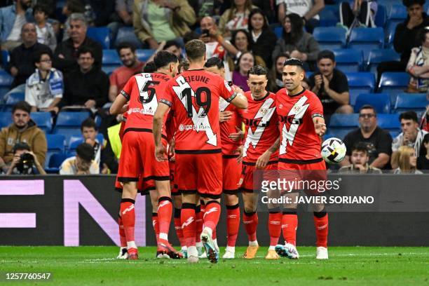 Rayo Vallecano's Spanish forward Raul de Tomas celebrates scoring his team's first goal with teamates during the Spanish league football match...