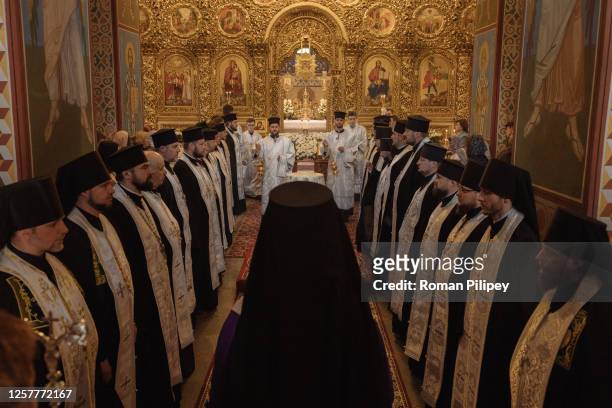 Ukrainian Orthodox priests and believers attend an evening service at Saint Michael's Golden-Domed Monastery, the headquarters of the Orthodox Church...