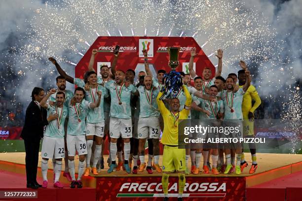 Inter Milan's Slovenian captain goalkeeper Samir Handanovic holds up the trophy as players celebrate their championship after winning the Italian Cup...