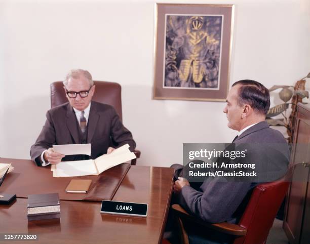 1960s Man Talking To Male Banker Loan Officer Loans Bank Desk