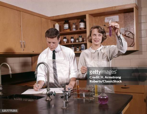 1960s Teenage Girl And Boy High School Students Working Together In Chemistry Science Lab