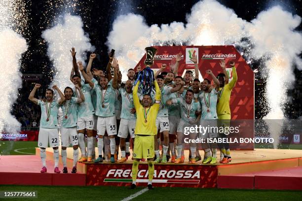 Inter Milan's Slovenian captain Samir Handanovic holds up the trophy as players celebrate their championship after winning the Italian Cup final...