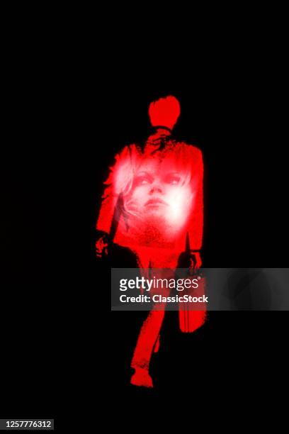 1970s Man Walking Away Carry Briefcase Face Of Woman Superimposed On His Back Red On Black Background Mystery Business