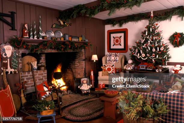 1980s Christmas Decorated Colonial Style Living Room Interior Fire In Fireplace And Festive Small Christmas Tree On Table USA