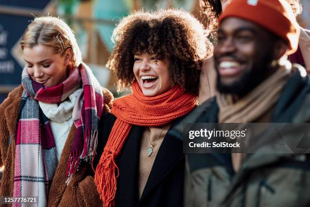 good friends laughing - winter walk stock pictures, royalty-free photos & images