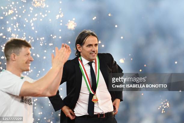 Inter Milan's Italian head coach Simone Inzaghi reacts during his team's celebration after winning the Italian Cup final football match between...