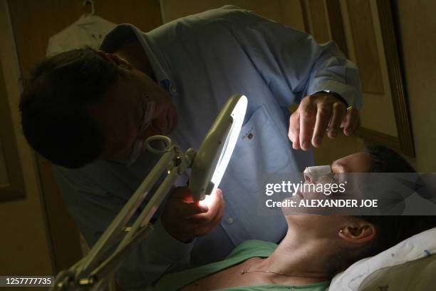 Sibongile Khumalo South African Doctor Rick examines the nose of a British patient who had plastic surgery Johannesburg on October 26, 2008. Forget...