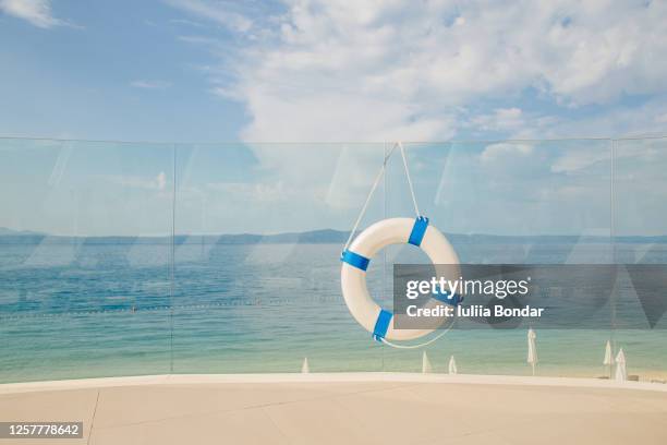 life buoy attached to a wooden paneled wall with plenty of copy space - life ring pool stock pictures, royalty-free photos & images
