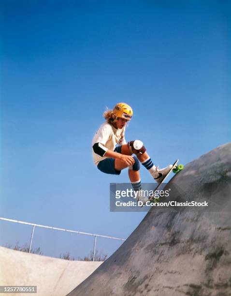 1970s Teenage Boy Wearing Safety Equipment Skateboarding On Skateboard Obstacle Course wearing Nike shoes