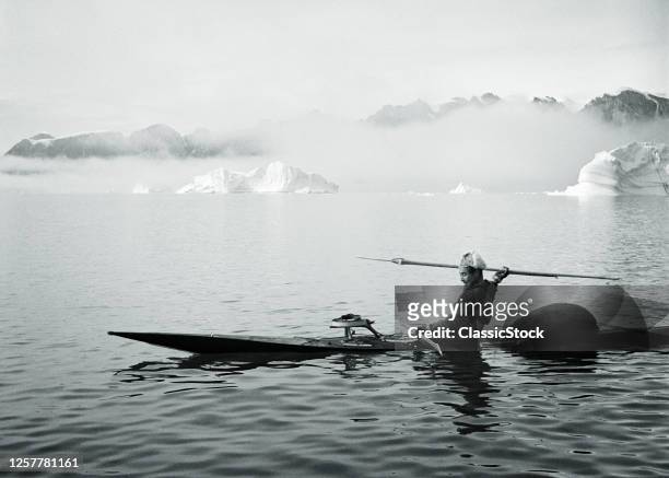 1950s Man Greenlandic Inuit Hunting Harpooner In Kayak At Sydkap In Eastern Greenland Part Of The Scoresby Sund Fjord System