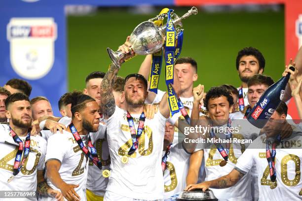 Liam Cooper of Leeds United lifts the trophy in celebration with team mates after the Sky Bet Championship match between Leeds United and Charlton...