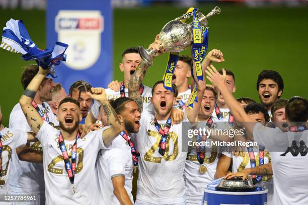 Liam Cooper of Leeds United lifts the trophy in celebration with team mates after the Sky Bet Championship match between Leeds United and Charlton...