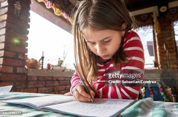happy little girl homeschooling, problems, rural-scene. - rural scene photos et images de collection