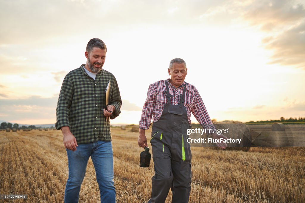 After they checked a quality of hay contented father and son going home