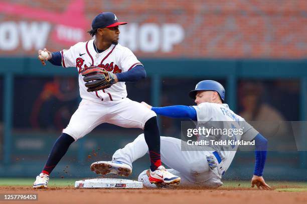 Freddie Freeman of the Los Angeles Dodgers is out at second as Ozzie Albies of the Atlanta Braves makes the play during the first inning at Truist...