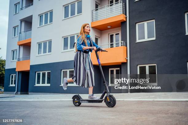 young woman on electric scooter - mobility scooter stock pictures, royalty-free photos & images