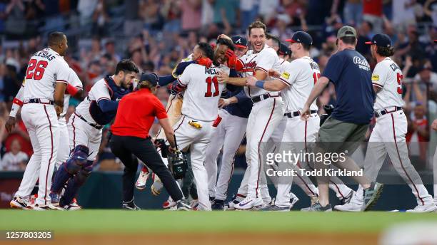 The Atlanta Braves celebrate a sacrifice fly to with the game against the Los Angeles Dodgers in the ninth inning at Truist Park on May 24, 2023 in...