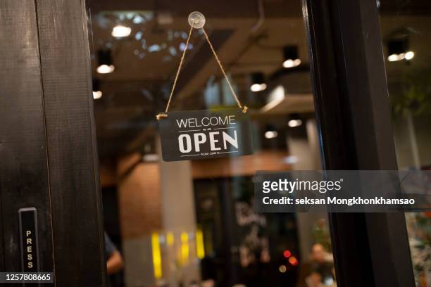 open sign on cafe hang on door at entrance. - placard imagens e fotografias de stock