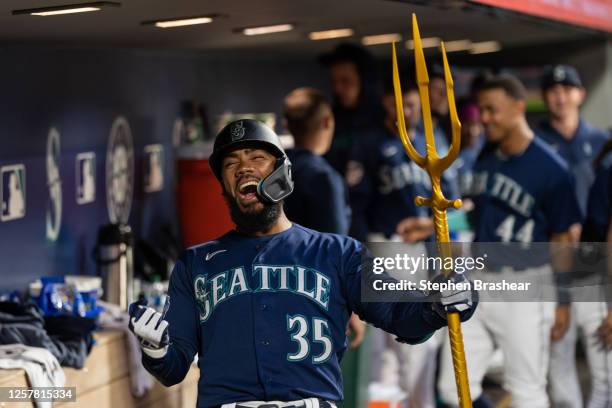 Teoscar Hernandez of the Seattle Mariners celebrates in the dugout after hitting a solo home run during the seventh inning against the Oakland...
