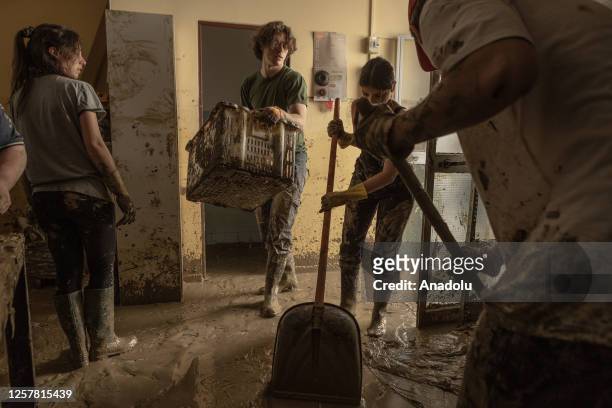 Inhabitants and volunteers continue to clean their homes and public buildings from the mud that remained after the city was overwhelmed by the flood...