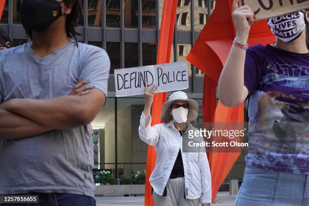 Activists hold a rally in the federal building plaza to protest the Trump administration's pledge to send federal agents into Chicago to deal with...