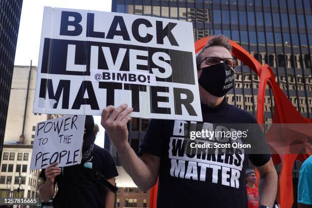 Activists hold a rally in the federal building plaza to protest the Trump administration's pledge to send federal agents into Chicago to deal with...