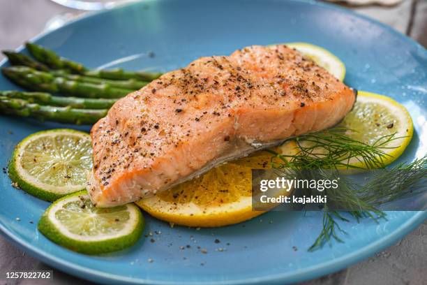 grilled fillet of salmon with asparagus served on a plate - baked salmon stock pictures, royalty-free photos & images