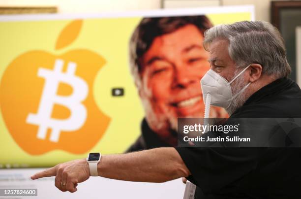 Apple co-founder Steve Wozniak wears a protective mask as he stands next to a photo of himself during a press conference on July 23, 2020 in...