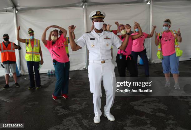 Vice Admiral Jerome Adams, the U.S. Surgeon General, during a light moment interacts with health care workers after he toured the new federally...