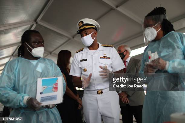 Vice Admiral Jerome Adams, the U.S. Surgeon General, speaks with RN's Gabriel Appoh and Varaiaia Barkus as he toured the new federally funded...