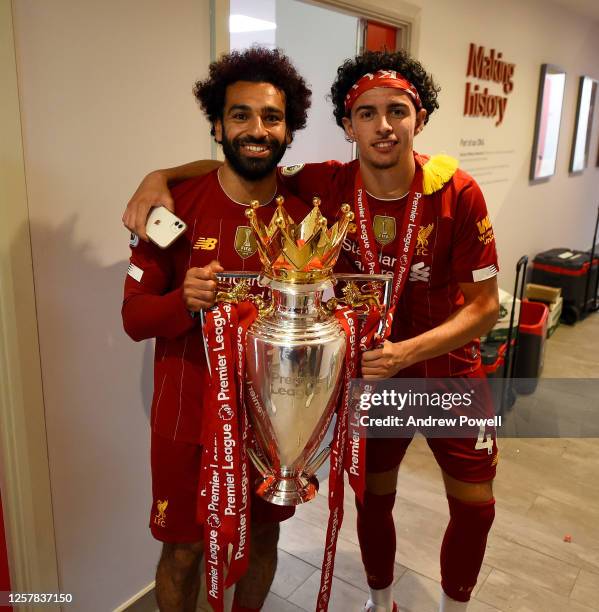 Mohamed Salah and Curtis Jones of Liverpool in the dressing room with the premier league trophy after winning the Premier league at the end of the...