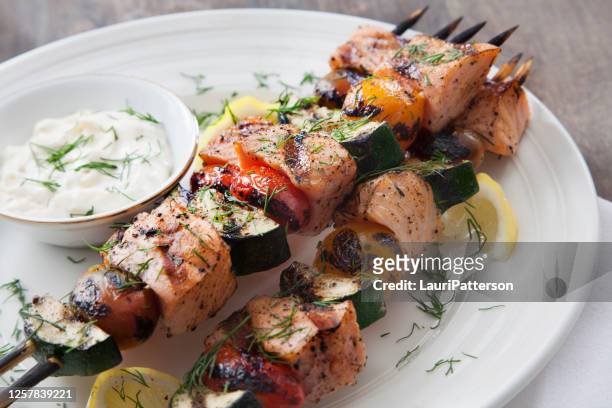 bbq salmon skewers with zucchini, tomatoes and tzatziki dip - greek food stock pictures, royalty-free photos & images