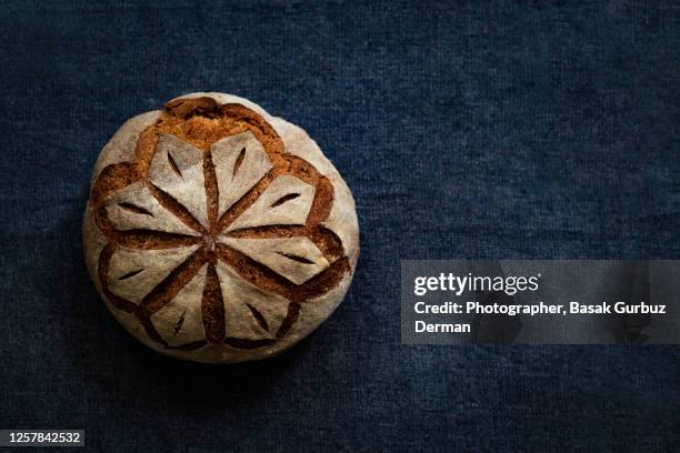 sourdough whole wheat bread with a beautiful scoring pattern - round loaf stock pictures, royalty-free photos & images