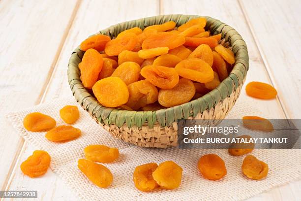 dried apricots in a basket - albaricoque fotografías e imágenes de stock