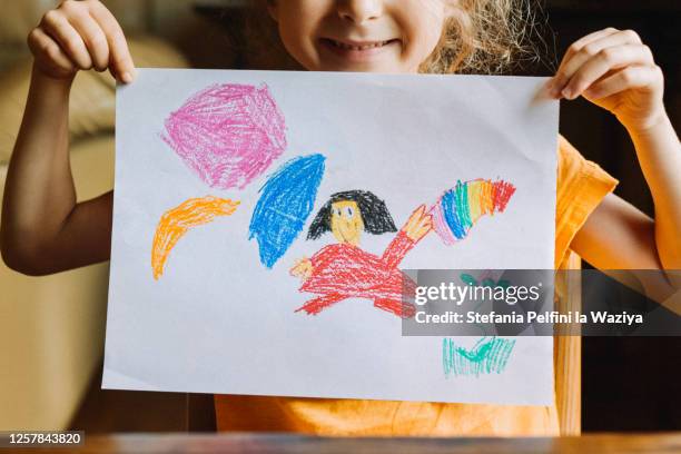 little girl showing her drawing - crayon drawing stock pictures, royalty-free photos & images