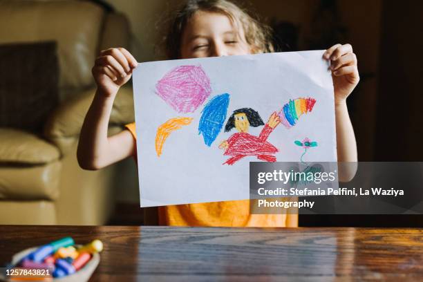 little girl showing her drawing - 絵画 ストックフォトと画像