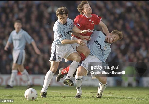 Eddie McGoldrick of Manchester City, Craig Hignett of Middlesbrough and Steve Lomas of Manchester City clash as they challenge for the ball during...