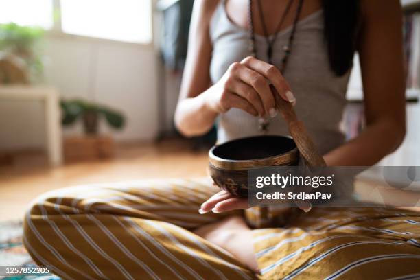 close-up of a female's hands holding a rin gong - rin gong stock pictures, royalty-free photos & images