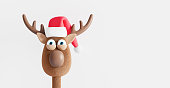 Funny Reindeer with Christmas hat isolated on white. Winter Holidays concept 3d render