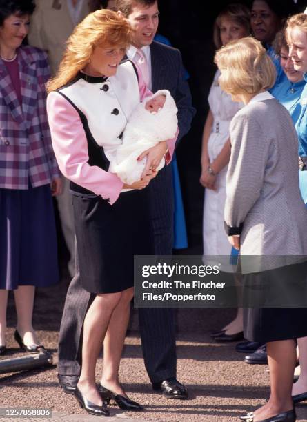 Prince Andrew with his wife, Sarah, Duchess of York, holding their infant daughter Princess Eugenie, outside the Portland Hospital in London on 30th...