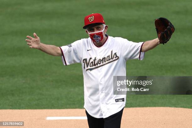 Dr. Anthony Fauci, director of the National Institute of Allergy and Infectious Diseases reacts after throwing out the ceremonial first pitch prior...