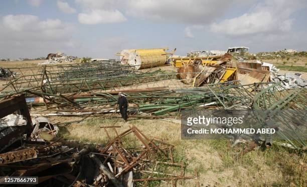 Taisir Abu Ida, the Palestinian co-owner of Abu Ida cement factory, walks past the rubble of its premises in Jabalia in the northern Gaza Strip on...